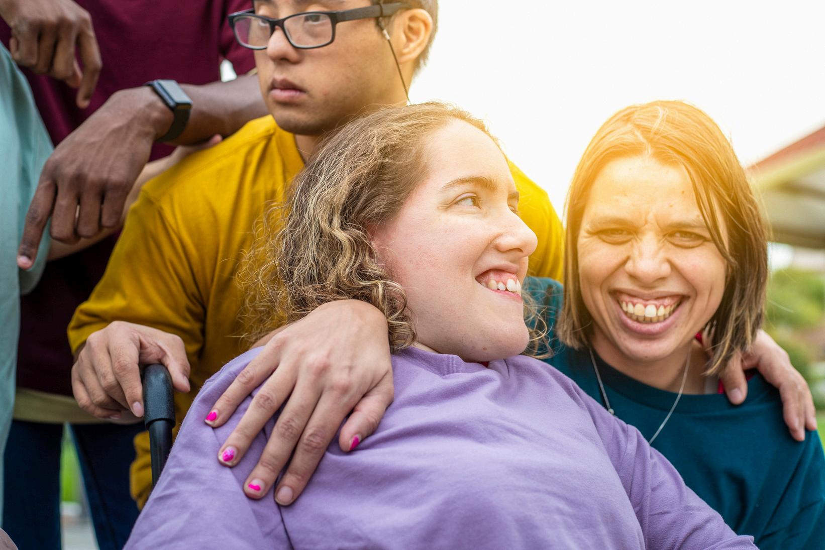 Photo of a diverse group of young smiling people with different disabilities.