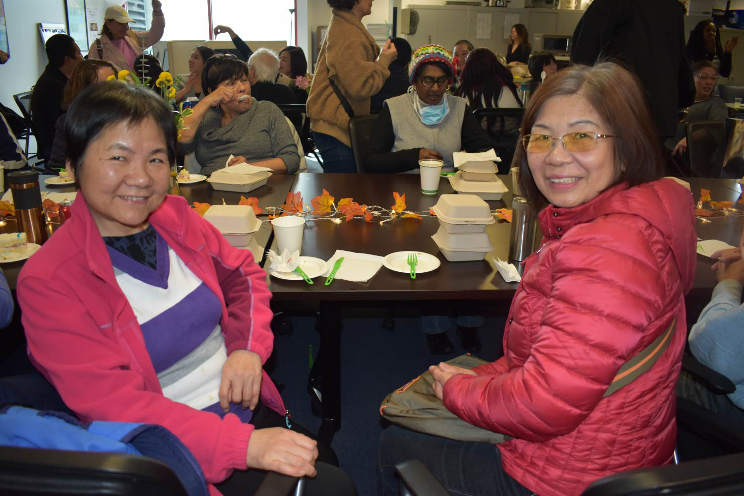 Photo of two female care providers sitting together at an event hosted by SFIHSSPA.