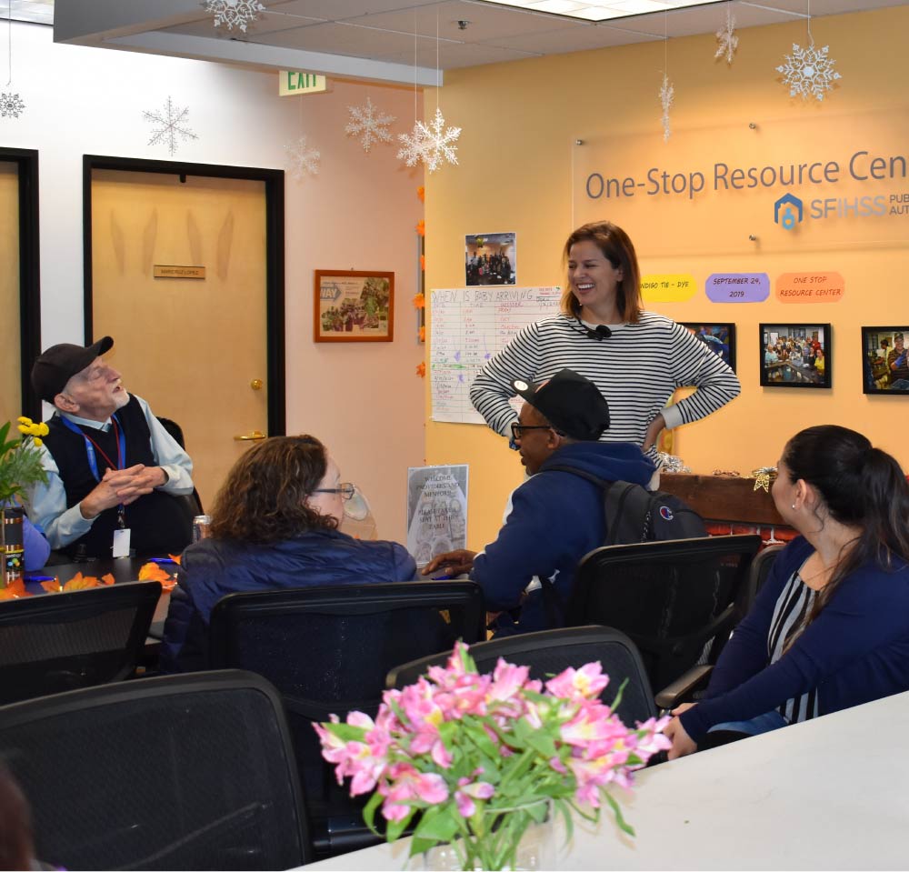 Photo of a SFIHSSPA staff member with Consumers at the One-Stop Resource Center.